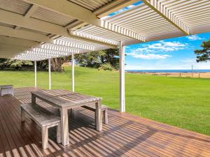 a wooden deck with a picnic bench under a pavilion at Kilcunda Coast House in Woolamai