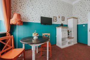 a small dining room with a table and a tv at Hostel Night o'clock in Opole