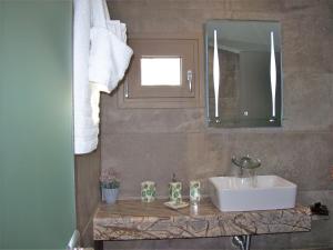 a bathroom with a sink and a mirror at Sea breeze 2 in Limenaria +33 photos