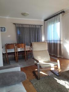 a living room with a chair and a table at Rakić apartman in Bajina Bašta