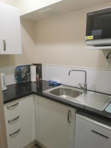 a kitchen counter with a sink and a microwave at Breakaway at York Bay in Days Bay