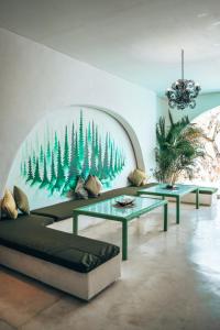 a living room with two couches and a mural of trees at Nazeki Villa in Uluwatu