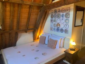 a bedroom with a bed with plates on the wall at Amsterdam Central Guest House in Amsterdam