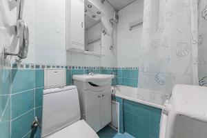 a bathroom with a toilet and a sink at Apartment Hanaka Zeleniy 83 in Moscow