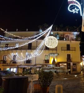 a building decorated with christmas lights at night at B&B La Piazzetta in Paola