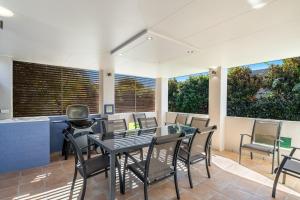 a dining room with a table and chairs at A Wave From It All - Lennox Head in Lennox Head