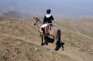 a person riding a horse on a hill at Sayyod Yurt Camp in Sayyod
