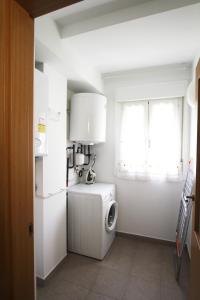 a kitchen with a refrigerator and a washing machine at Apartamento Labegain 6 in Sestao