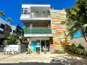 a building with a colorful facade with palm trees at Amable Suites Hotel in Boracay