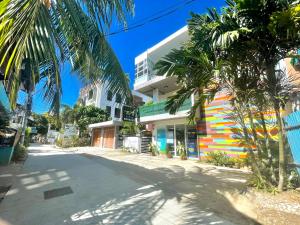 a street with palm trees in front of a building at Amable Suites Hotel in Boracay