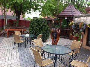 a patio with tables and chairs and a gazebo at Sarokhaz Panzio in Vecsés