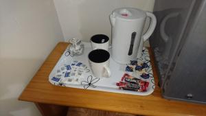 a table with a blender and cups on it at Room in Guest room - En suite shower room Double room with 1 double deyr in Hayes