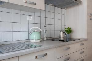 a kitchen with a teapot sitting on a counter at Residenza Ester in Riva del Garda +41 photos
