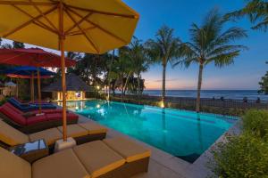 a swimming pool with a view of the ocean at InBalance Resort in Lovina