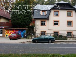 a green car parked in front of a building at Holiday Apartments Vítězná 1256/36 in Karlovy Vary
