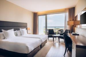 a hotel room with a bed and a desk at Iberostar Selection Lagos Algarve in Lagos