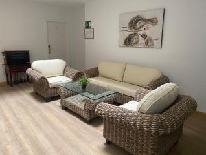 a living room with two couches and a coffee table at Mare Estepona Hotel in Estepona