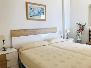 Postel nebo postele na pokoji v ubytování EDIFICIO PEÑON DE IFACH