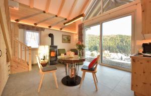 a kitchen and living room with a table and chairs at Chalets am Rößle in Todtmoos