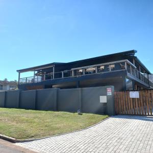 a building with a fence in front of it at Le Bezz Guesthouse in Ballito
