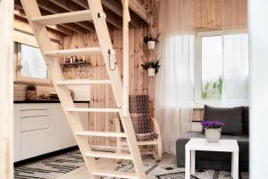 a loft bed in a kitchen with a living room at Rouna Family Home in Ainja