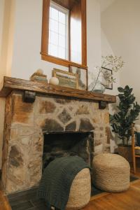 a stone fireplace with a mirror on top of it at The Woodlawn Tudor in Hot Springs