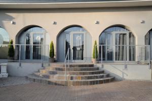 a building with a set of stairs in front at Hotel Cavallo Bianco in Reggiolo