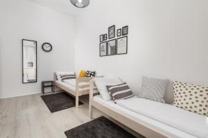 a living room with two couches and a clock on the wall at St. Vitus in Rijeka