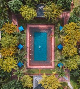 an overhead view of a pool in a garden with trees at Melati Beach Resort & Spa in Choeng Mon Beach