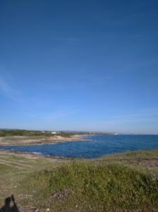 a shadow of a person taking a picture of the ocean at IL PRINCIPE VIENDALMARE in Ostuni