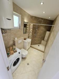 a bathroom with a toilet sink and a shower at Lux apartmani Darija in Kotor