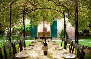 a table with glasses and a bottle of wine at Villa Larniano in Siena