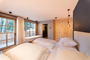 Кровать или кровати в номере Penserhof - Alpine Hotel & Restaurant