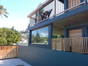 a house with a balcony with a view of the mountains at Le Bezz Guesthouse in Ballito