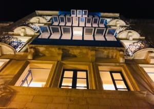 a close up of a building at night at Hotel Pjazza Merkanti - Boutique Living in Valletta