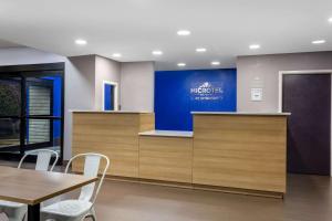 a meeting room with a desk and a table and chairs at Microtel Inn & Suites by Wyndham Matthews/Charlotte in Matthews