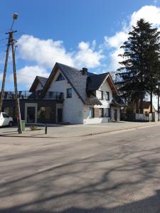 a house on the side of a street at Apartament Limonka in Wierzchucino