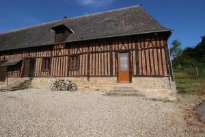 a building with a bike parked in front of it at Sauna et jacuzzi - Les mille et une nuits - 2km mer in Le Bourg-Dun