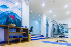 a gym with a wall mural of a mountain at Camp Netanya Resort and Spa in Mabini