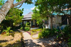 a house with a garden in front of it at A Rocha Eco-Lodge & Conservation Centre in Watamu