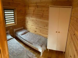 a room with two beds in a log cabin at Mazurski Domek in Mikołajki