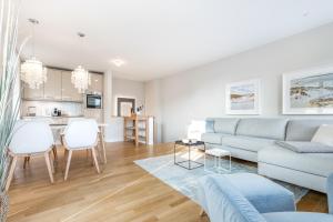a living room with a couch and a table at Sylt four Seasons II in Wenningstedt +16 photos