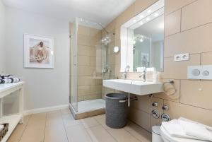 a bathroom with a sink and a shower at Sylt four Seasons II in Wenningstedt