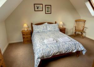 a bedroom with a bed with two towels on it at Church House Farm in Danby