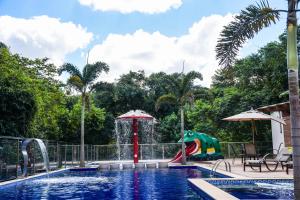 a pool with a water park with a dinosaur playground at Hotel Chapadao Da Canastra in São Roque de Minas