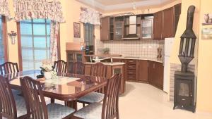 a kitchen with a table and chairs and a stove at Vila Exotic in Kavadarci