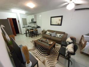 a living room with a couch and a table at South seas safari @ The Bridge apartments in St Lucia