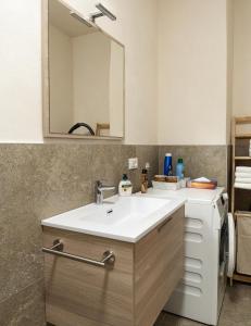 a bathroom with a white sink and a mirror at Flow Apartments Kirchsteig in Merano