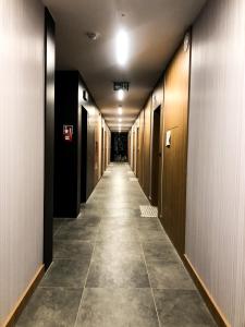 a hallway with a long row of elevators in a building at Apartament Bastion Wałowa Gdańsk in Gdańsk