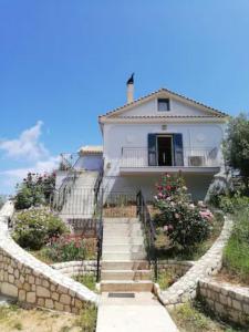 una casa bianca con scale che la conducono di OliveTree House a Vathi